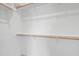 Walk in closet with white walls and wooden closet rods for ample storage at 808 Shiloh Hills Dr, Fuquay Varina, NC 27526