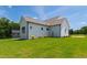 Exterior shows expansive yard with recently planted landscaping and modern architectural details at 808 Shiloh Hills Dr, Fuquay Varina, NC 27526