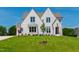 Stunning two-story home with a white brick exterior, manicured lawn, and professional landscaping at 808 Shiloh Hills Dr, Fuquay Varina, NC 27526