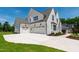 Stunning home exterior features a large driveway and three-car garage, providing ample parking at 808 Shiloh Hills Dr, Fuquay Varina, NC 27526