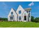 Elegant front exterior of a two-story brick home features a manicured lawn at 808 Shiloh Hills Dr, Fuquay Varina, NC 27526