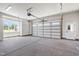 Spacious and bright three-car garage with modern features including a window and pedestrian door at 808 Shiloh Hills Dr, Fuquay Varina, NC 27526