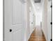 Bright hallway with hardwood floors, white doors, trim, and natural light creates an open atmosphere at 808 Shiloh Hills Dr, Fuquay Varina, NC 27526