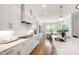 Gourmet kitchen with gas range, stone counters, subway tile backsplash and custom range hood at 808 Shiloh Hills Dr, Fuquay Varina, NC 27526
