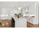 Bright, modern kitchen features white cabinetry, hardwood floors, and a large center island at 808 Shiloh Hills Dr, Fuquay Varina, NC 27526