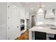 Modern kitchen featuring white cabinets, hardwood floors and stainless appliances at 808 Shiloh Hills Dr, Fuquay Varina, NC 27526