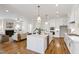 Open concept kitchen with island seating flows into the living room, perfect for entertaining at 808 Shiloh Hills Dr, Fuquay Varina, NC 27526