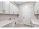 Well-equipped laundry room featuring modern white cabinets, stylish hardware, and countertops for functionality at 808 Shiloh Hills Dr, Fuquay Varina, NC 27526