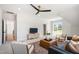 Bright living room offering a ceiling fan, plush seating, and large windows, creating a relaxing space at 808 Shiloh Hills Dr, Fuquay Varina, NC 27526