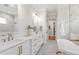 This main bathroom has marble floors, a double sink vanity, a soaking tub, and a glass shower at 808 Shiloh Hills Dr, Fuquay Varina, NC 27526