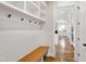 The mudroom includes custom shelving and a bench, with a view into the living room and kitchen at 808 Shiloh Hills Dr, Fuquay Varina, NC 27526