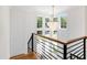 Bright foyer staircase featuring a modern chandelier and natural light streaming through large windows at 808 Shiloh Hills Dr, Fuquay Varina, NC 27526