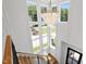 Bright foyer staircase featuring a modern chandelier and natural light streaming through large windows at 808 Shiloh Hills Dr, Fuquay Varina, NC 27526
