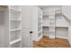 This is the walk-in closet, which includes custom shelving and wood floors at 808 Shiloh Hills Dr, Fuquay Varina, NC 27526