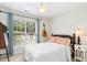 Bedroom with guitar on the wall, a large window and ceiling fan at 8513 Buscot Ct, Raleigh, NC 27615