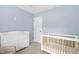 Serene Bedroom with a crib and dresser, featuring a soothing color palette at 8513 Buscot Ct, Raleigh, NC 27615