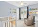 Charming Bedroom featuring a crib, comfortable seating, and window with plenty of natural light at 8513 Buscot Ct, Raleigh, NC 27615