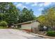 Exterior view of the community clubhouse featuring a parking lot and lush trees at 8513 Buscot Ct, Raleigh, NC 27615