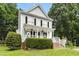 Charming two-story home featuring a welcoming front porch, black shutters, and a well-manicured lawn at 8513 Buscot Ct, Raleigh, NC 27615