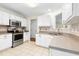 Bright kitchen with stainless steel appliances, white cabinets, and tile floors at 8513 Buscot Ct, Raleigh, NC 27615