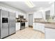 Bright kitchen with stainless steel appliances, white cabinets, and tile floors at 8513 Buscot Ct, Raleigh, NC 27615