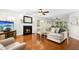 Bright living room with fireplace, hardwood floors, and comfortable seating area at 8513 Buscot Ct, Raleigh, NC 27615