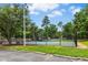 Community tennis court in a fenced-in area with a visible net and green and blue surface at 8513 Buscot Ct, Raleigh, NC 27615