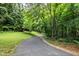 Scenic paved walking trail surrounded by lush greenery and trees, inviting leisurely strolls at 8513 Buscot Ct, Raleigh, NC 27615
