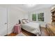 Inviting bedroom with hardwood floors, a window with backyard views, and a cozy atmosphere at 905 Aversboro Rd, Garner, NC 27529