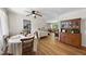 Sunlit dining area with hardwood floors, ceiling fan, and stylish hutch at 905 Aversboro Rd, Garner, NC 27529