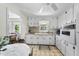 Functional kitchen features white cabinetry and eat-in dining area at 905 Aversboro Rd, Garner, NC 27529