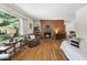 Living room showcasing a brick fireplace, wood floors, and natural light at 905 Aversboro Rd, Garner, NC 27529