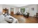 Cozy living room featuring hardwood floors and natural light from the expansive window at 905 Aversboro Rd, Garner, NC 27529