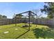 Large backyard featuring a fire pit, pergola, and swing for relaxing, with a privacy fence at 10 Wilders Ln, Louisburg, NC 27549