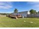 Well-maintained backyard featuring a wooden deck and lush green grass at 10 Wilders Ln, Louisburg, NC 27549
