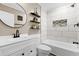 Bright bathroom has a tub with white tile surround and modern fixtures at 10 Wilders Ln, Louisburg, NC 27549