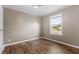 This bedroom features wood laminate flooring and a window with outside view at 10 Wilders Ln, Louisburg, NC 27549