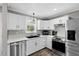 Stylish kitchen with white cabinets, a stainless steel dishwasher, and elegant backsplash at 10 Wilders Ln, Louisburg, NC 27549
