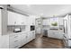 Modern kitchen features white cabinetry, stainless steel appliances, and sleek countertops at 10 Wilders Ln, Louisburg, NC 27549