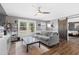 Inviting living room boasts a comfortable gray sofa, large windows, and a modern ceiling fan at 10 Wilders Ln, Louisburg, NC 27549