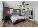 Main bedroom showcases a striking accent wall, modern lighting, and a sliding barn door to the ensuite at 10 Wilders Ln, Louisburg, NC 27549