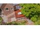 Aerial view of a brick home with a wooden back deck including patio seating at 1007 W Markham Ave, Durham, NC 27701