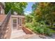 Backyard features a brick patio, garden and upper level balcony at 1007 W Markham Ave, Durham, NC 27701