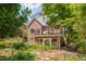 Manicured garden surrounding the brick home, featuring a balcony at 1007 W Markham Ave, Durham, NC 27701