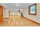 Finished basement with light wood floors and a staircase leading to the upper level at 1007 W Markham Ave, Durham, NC 27701