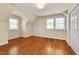 Neutral bedroom features two large windows and hardwood floors, providing a bright and airy atmosphere at 1007 W Markham Ave, Durham, NC 27701