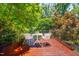 Inviting wood deck with table and chairs, perfect for enjoying the surrounding lush greenery at 1007 W Markham Ave, Durham, NC 27701