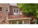 Second story deck overlooking a brick exterior and backyard greenery at 1007 W Markham Ave, Durham, NC 27701