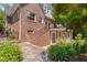 Beautiful brick home with a charming balcony and a lush garden at 1007 W Markham Ave, Durham, NC 27701