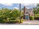 Front exterior of a brick home with a landscaped yard and charming blue door at 1007 W Markham Ave, Durham, NC 27701